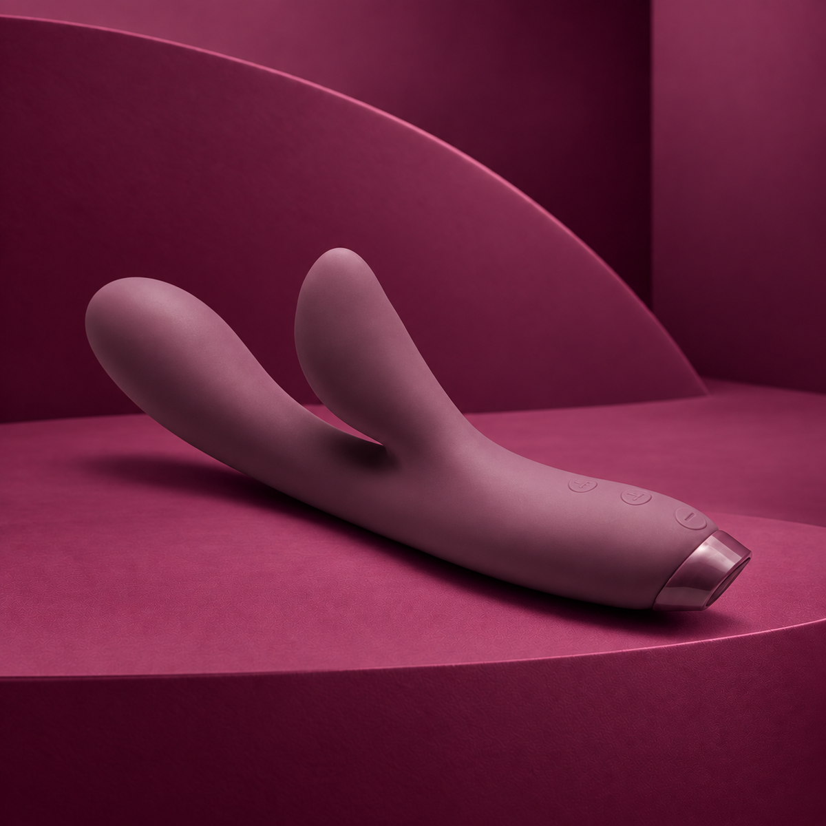 Je Joue Hera purple dual arm vibrator with three handle controls on red geometric background