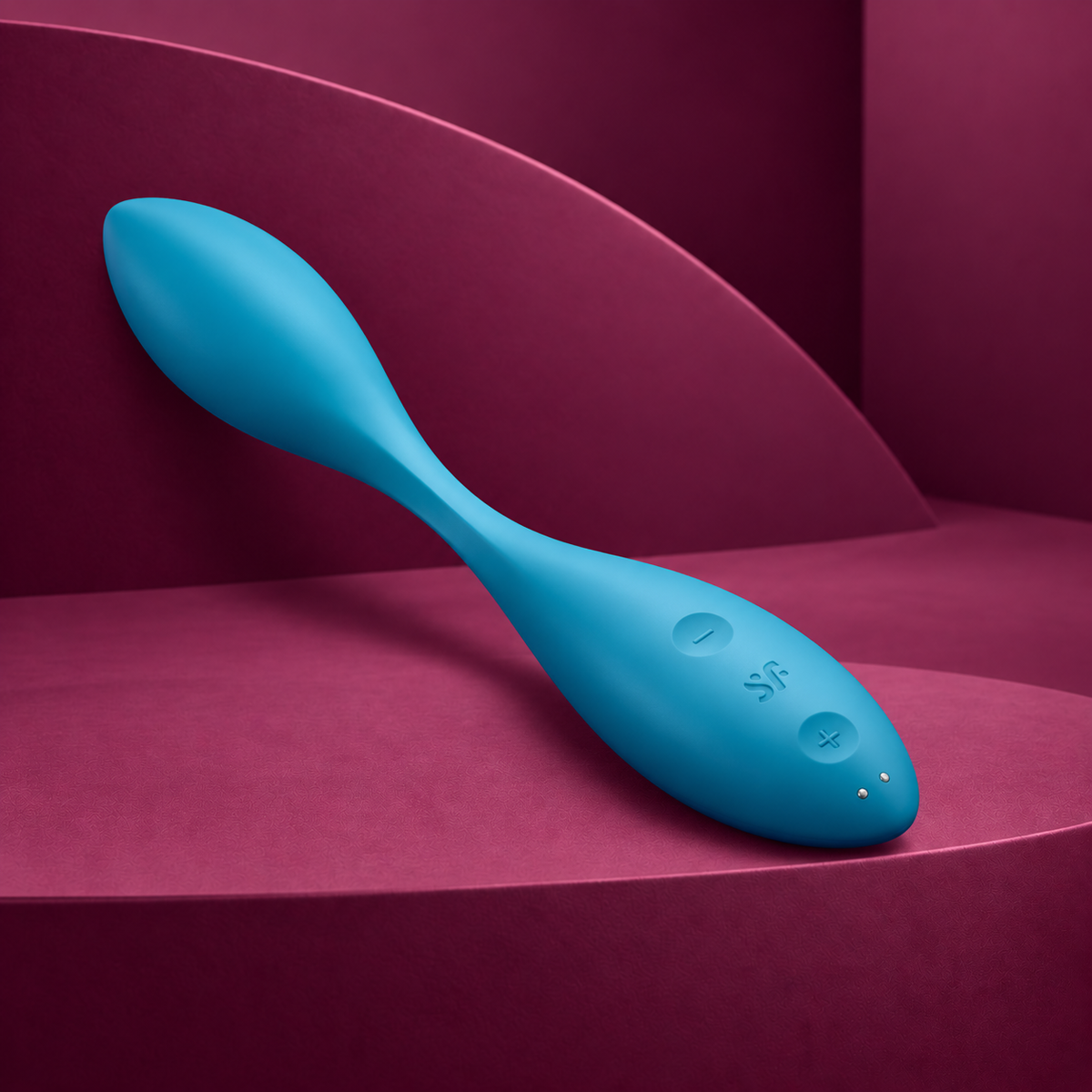 Satisfyer Flex 1 blue vibrator with minus, SF, plus and two charging contacts on red geometric background