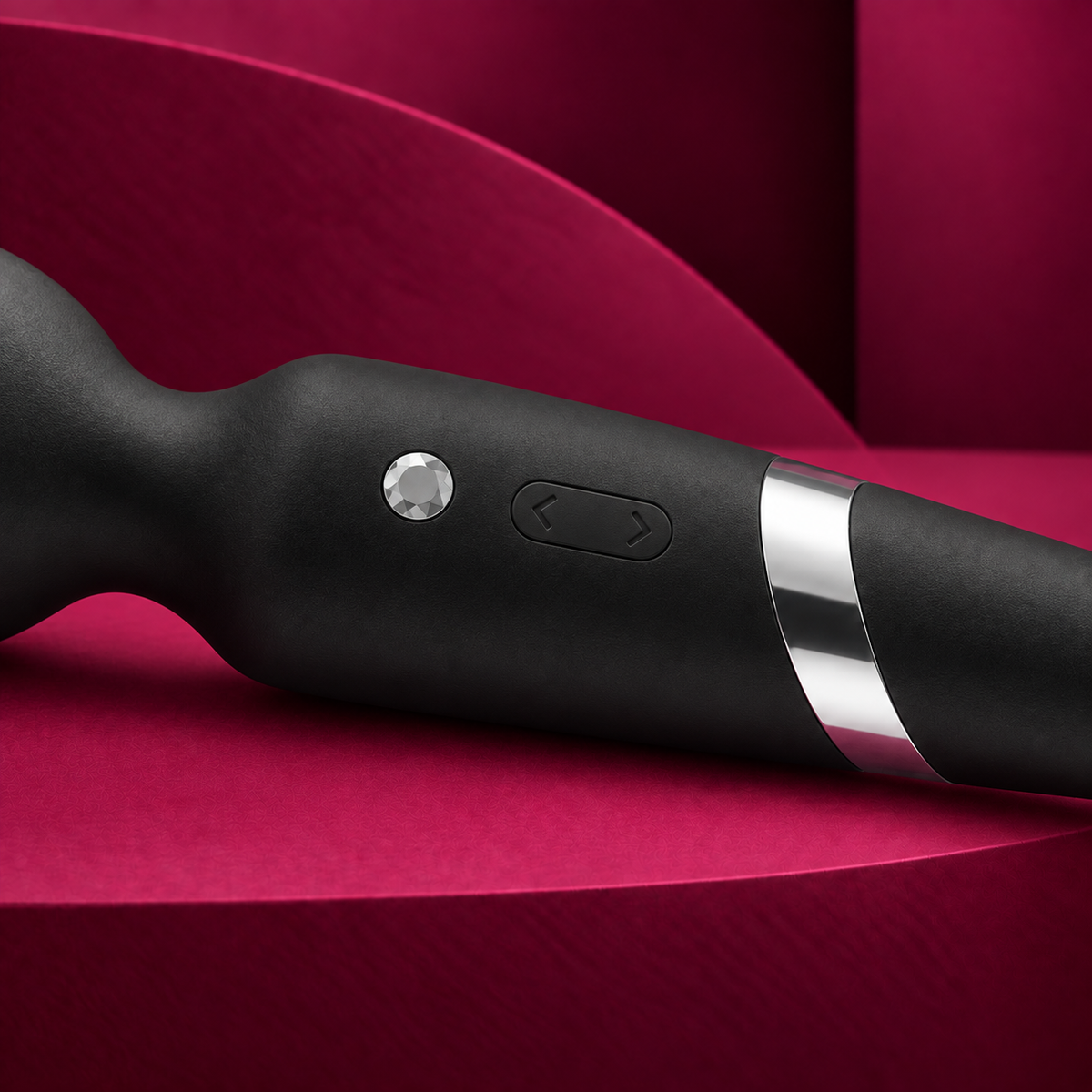 Black and silver Beck wand controls and silver collar on red geometric background