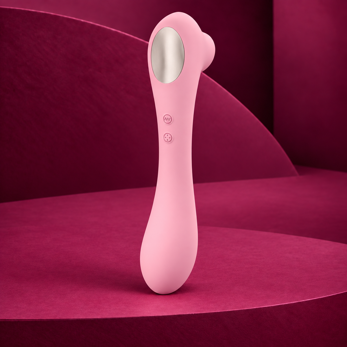 Femintimate Daisy pink suction massager with silver oval panel and two controls on red geometric background