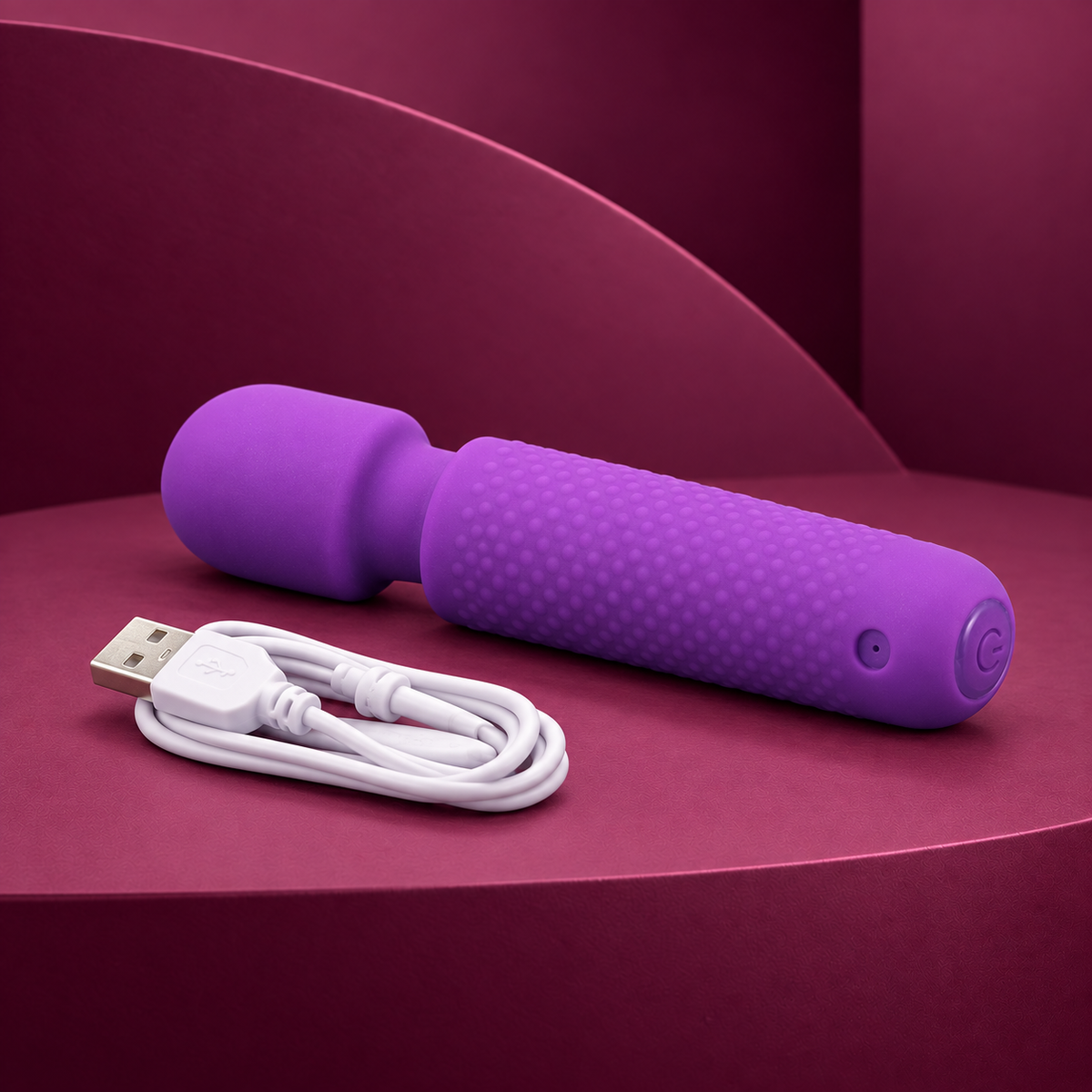 Armony Your magic massager, purple wand with white USB charging cable on red geometric background