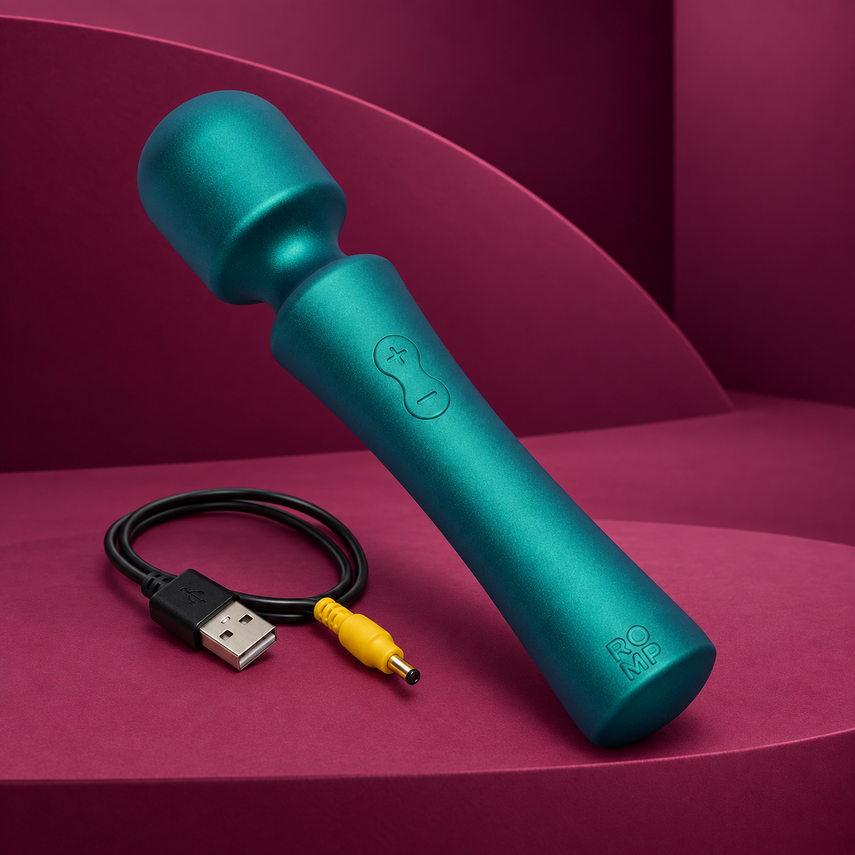 ROMP Presto green mini wand with charging cable on red geometric background