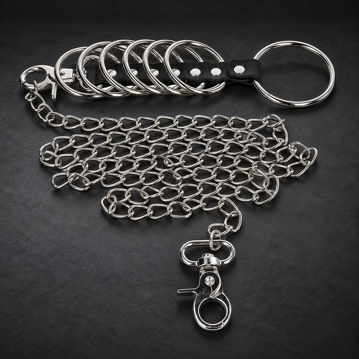 Kink 7 metal penis rings 3.8 cm to 5 cm connected with leather and metal chain 100 cm